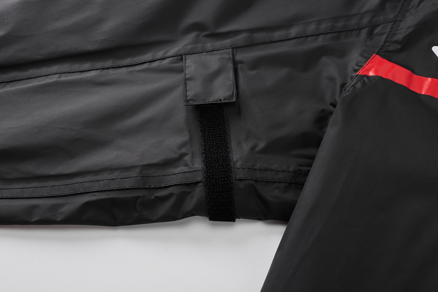 Imperial Red variant — adjustable waist tab with hook-and-loop closure, red upper-arm print in frame