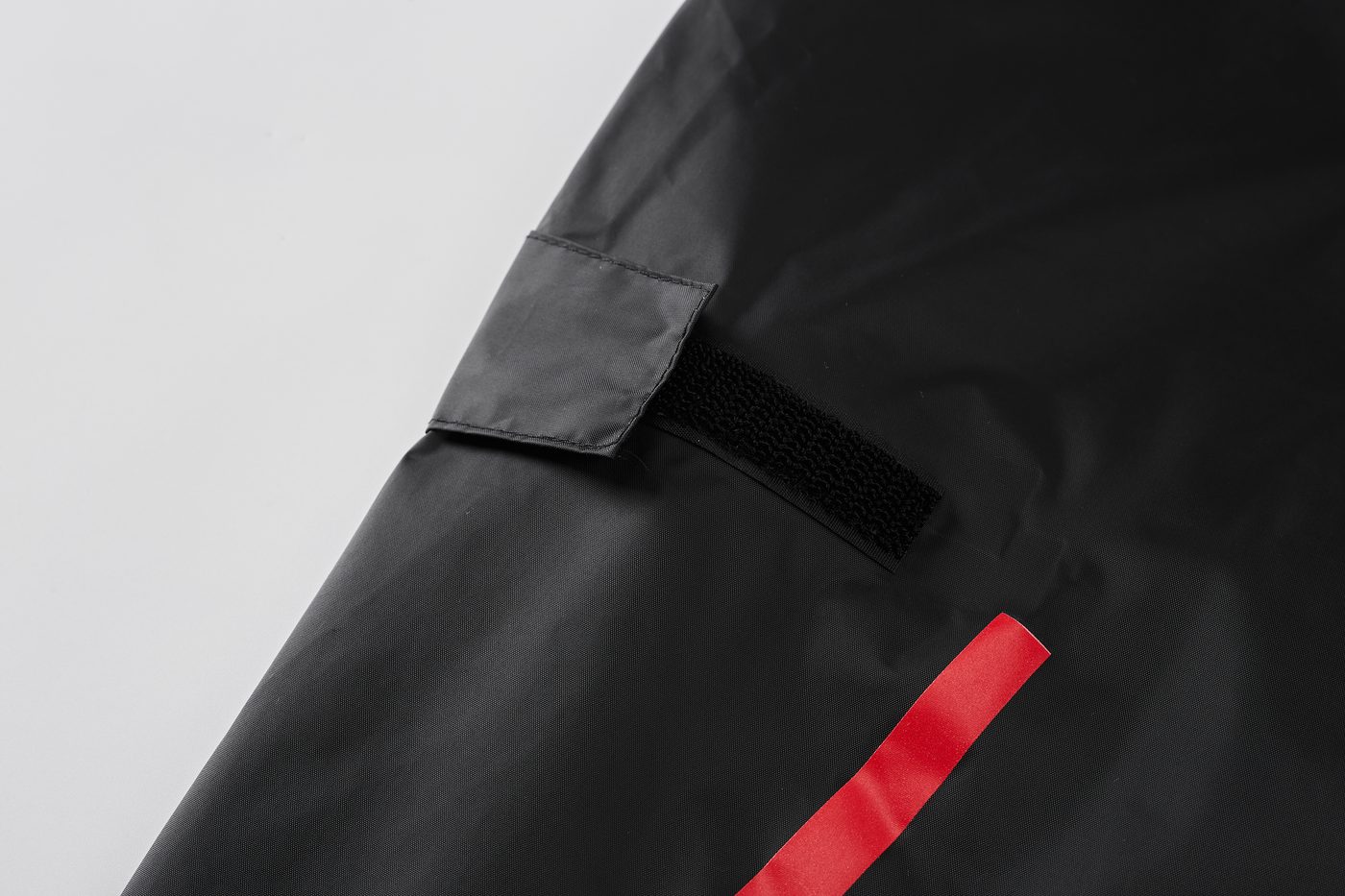 Adjustable hook-and-loop tab on the upper arm — the arm has no pocket