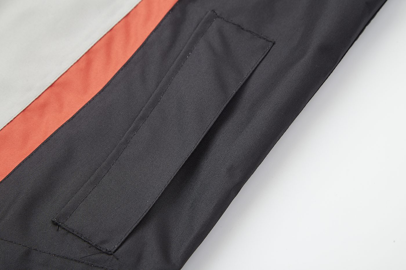 Side pocket with orange-red accent stripe on the black colorway